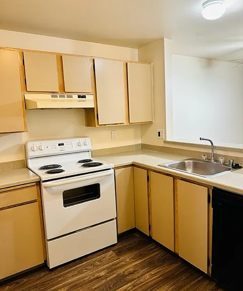 Spacious kitchen in unit with original finishes.