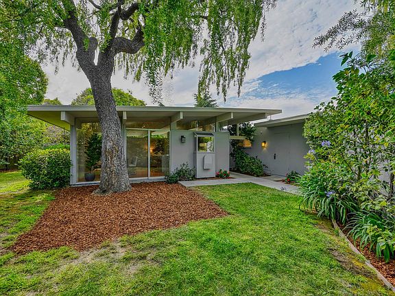 This charming home is nested within a cul-del-sac surrounded by lush landscaping.