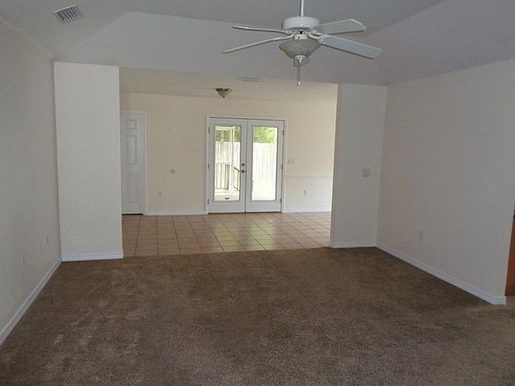 Large Living room leading to bonus area, lanai, and dining.