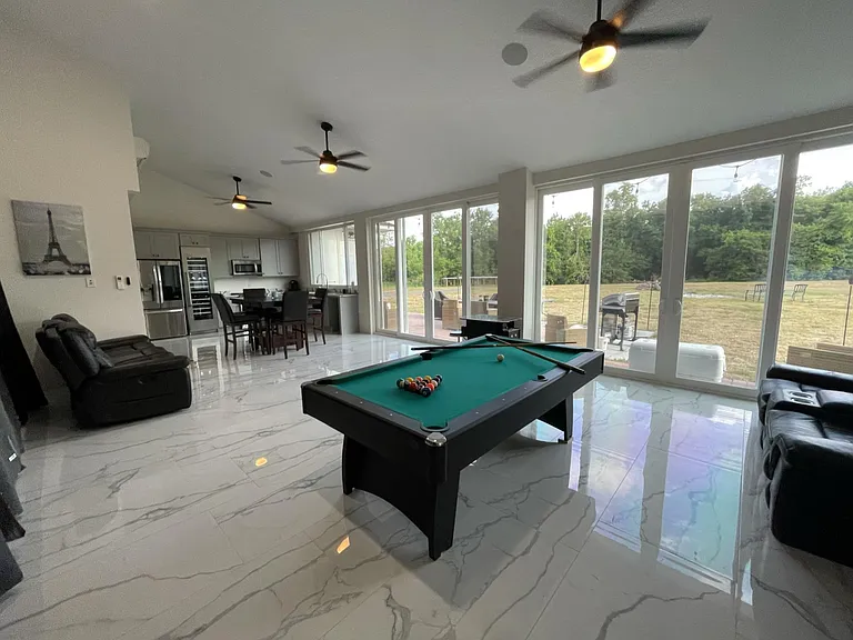 Full view of entertainment area with floor to ceiling windows.
