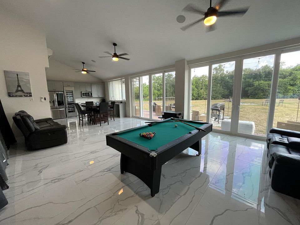 Full view of entertainment area with floor to ceiling windows.