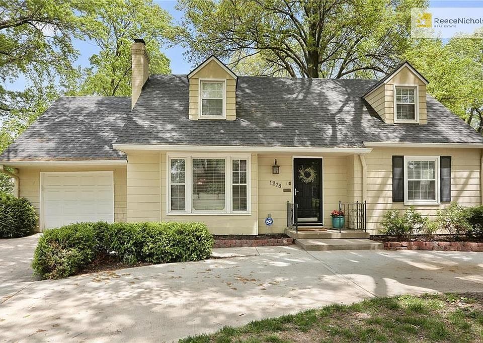 This charming Romanelli Cape Cod with circle drive and attached garage is TOO CUTE!