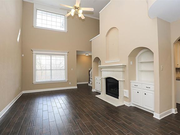 JUST ON THE OTHER SIDE OF THE ENTRY IS THE LIVING ROOM WITH BRAND NEW WOOD FLOOR TILE