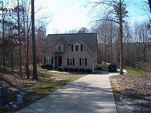 Front of home with long cement driveway