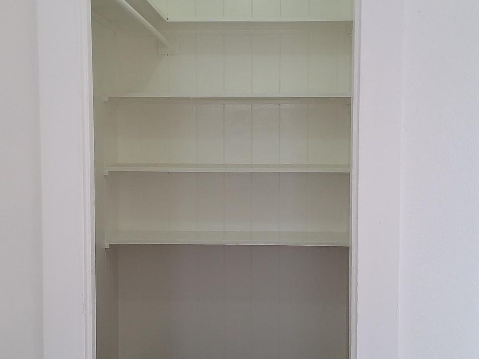 Walk in clothes closet with ceiling light