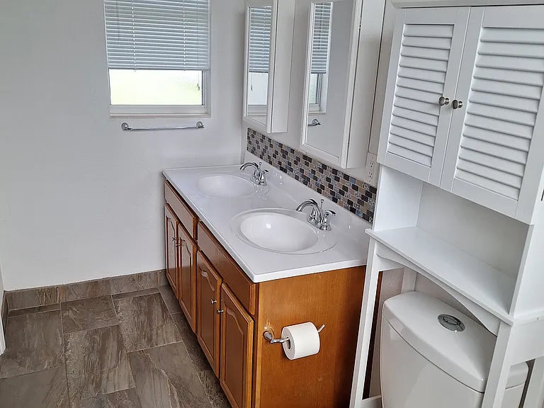 Adjoining Bathroom with double sinks and walk in Shower
