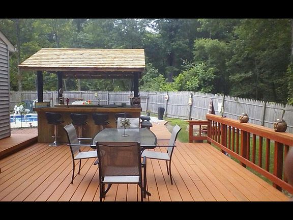 Large deck with board walk to built in 8 1/2 foot deep pool. Fence is older.