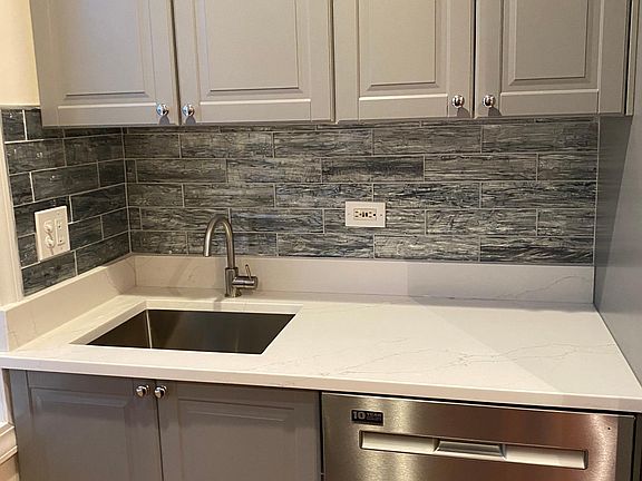 New sink, new dishwasher, new backsplash, new cabinets, and new quartz countertops