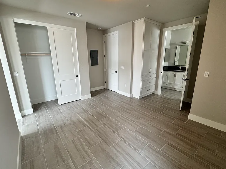 Bedroom, showing full closet, built-in storage cabinet/drawers and entrance to bath