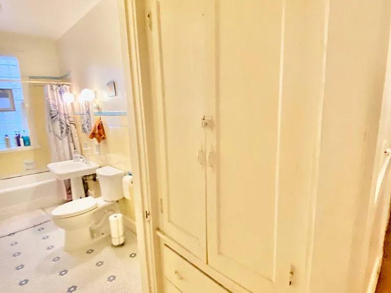 Large linen closet and drawers outside of larger bathroom