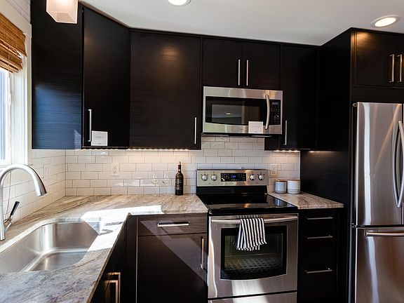 Fresh modern kitchen with under counter lighting, soft close cabinets and stainless appliances.