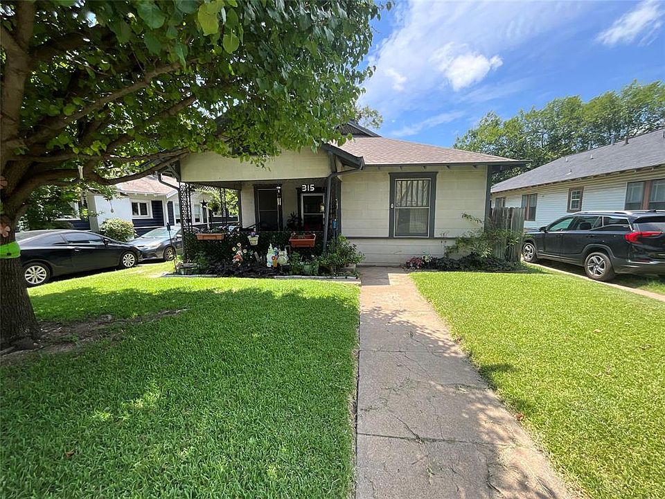 Bungalow with a front yard, covered porch, and a shingled roof