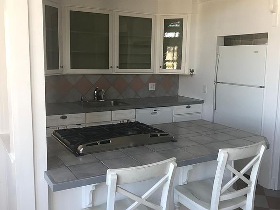 kitchen utility table and chairs. Gas oven/stove, refrigerator, d/w & garbage disposal