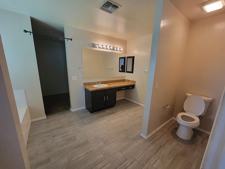 Master Bath with Toilet and View of Closet