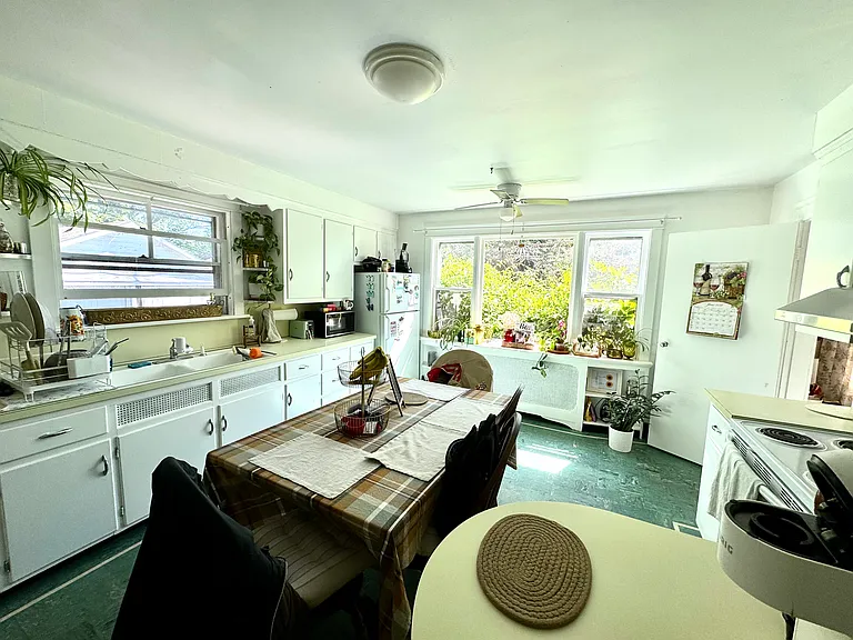 The kitchen has large windows providing plenty of natural light