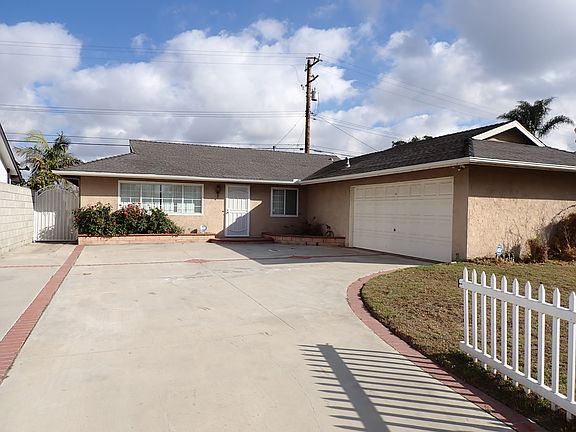 Large driveway and gated yard