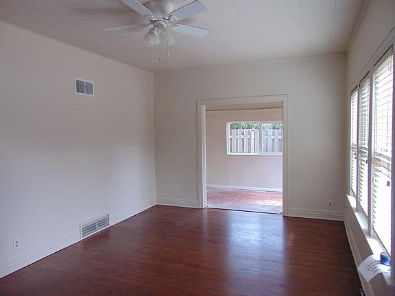 Living room with hardwood floors and ceiling fan