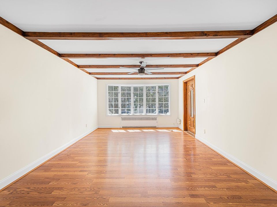 Tremendous Living Room with Beautiful New Flooring and Large Bay Window