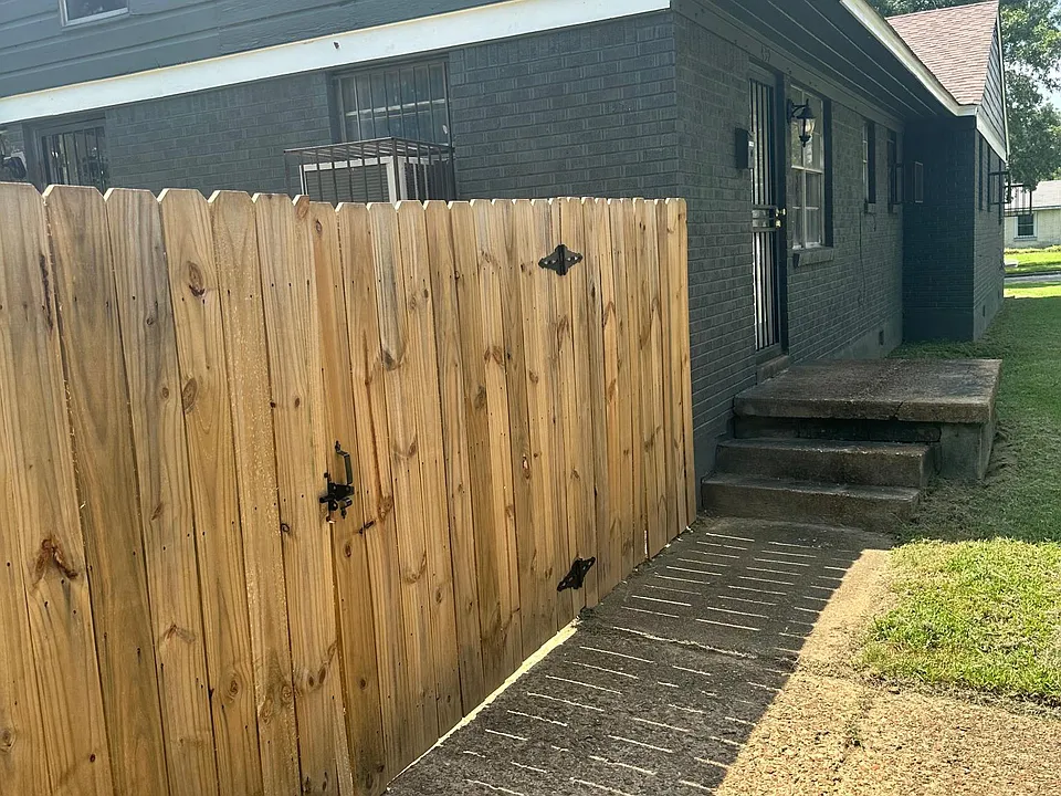 Side view with privacy fence and driveway