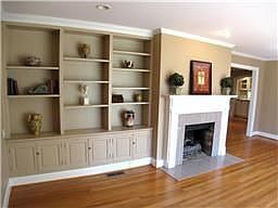 Charming living room opens to the wide entry hall with hardwood floors.