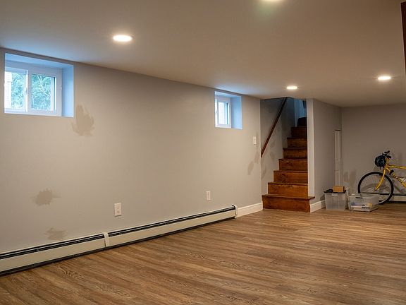 Another view of the lounging area + stairs going up to shared kitchen