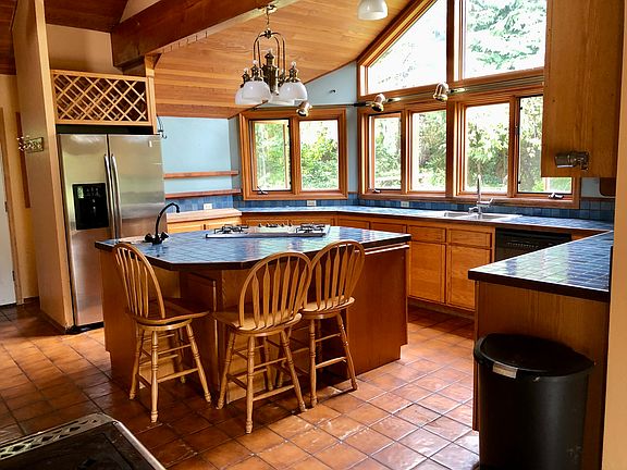 Kitchen with island. Tile counters and floors.