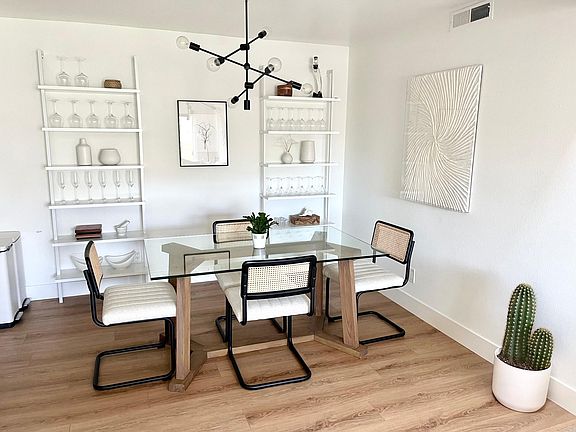 Dining room open to kitchen (left) and living room (behind)