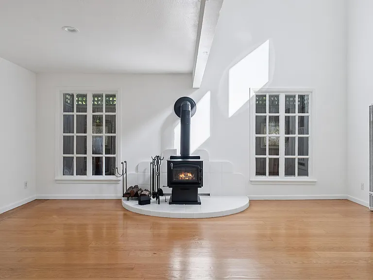 Great Room with fabulous windows, soaring ceilings and wood burning stove