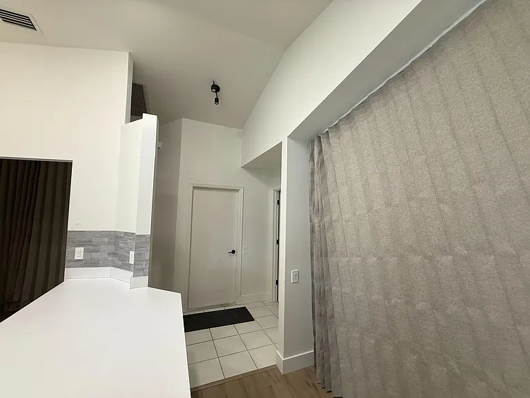 across from kitchen curtain is used to enclose room from outside room
