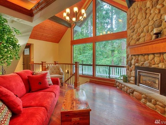 There are soaring ceilings, great millwork and a river rock fireplace with a propane insert! Check out the high end railing...