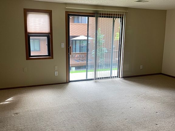 Large 750 soft room with two windows and sliding glass door to private patio.
