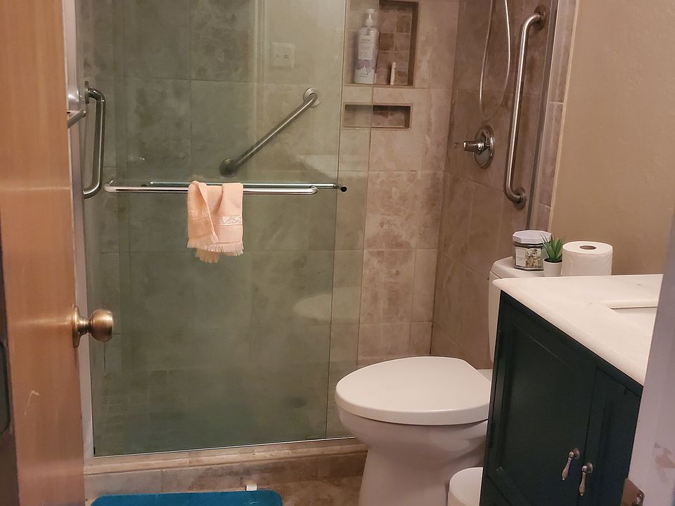 Private bathroom with a glass enclosed walk in shower (no bathtub) and plenty of storage space for toiletries, towels and personal belongings.