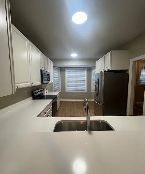 kitchen with new appliances and quartz countertops