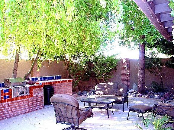 Entertainment Backyard with built-in grill & wraparound bar seating & serving 