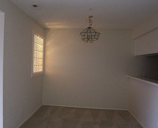 dining room off living room with pass through to kitchen & glass block window 