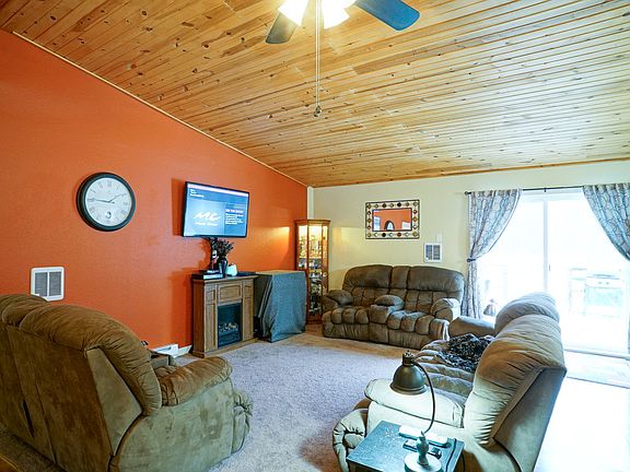 The vaulted wood ceilings really add to the welcoming feel of this great room. Ceiling fans are found throughout the house.  