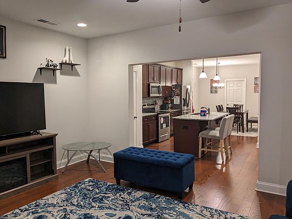 View from Great room towards kitchen and dining area, the door next to dining area is laundry.