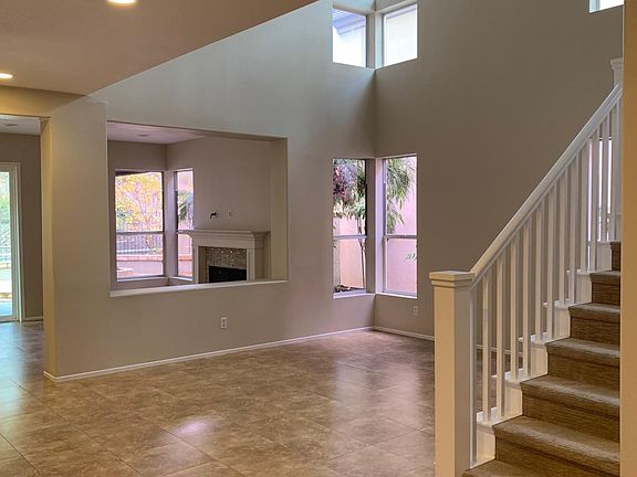 Formal living room with cathedral ceilings and lots of window for natural light