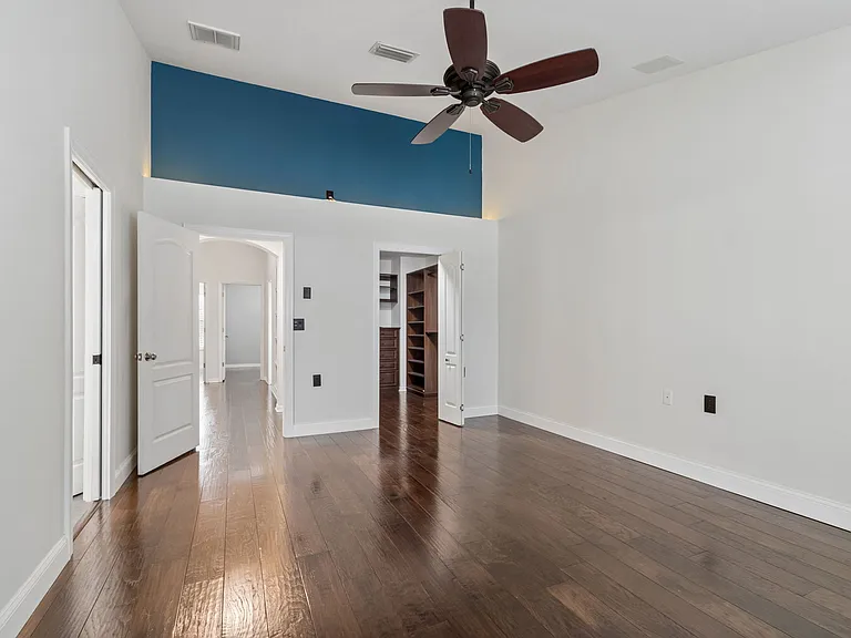 Primary Bedroom with massive walk in closet and balcony for retreats
