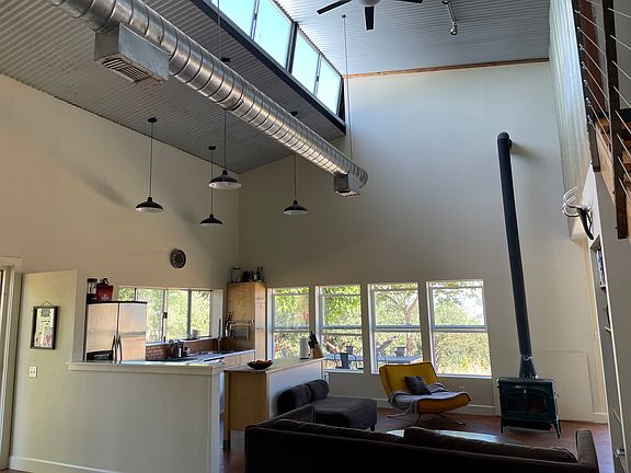 Open kitchen, seating area, wood stove, stunning views in every direction.