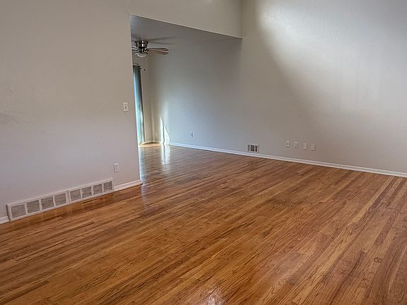 Living room with vaulted ceiling and skylights