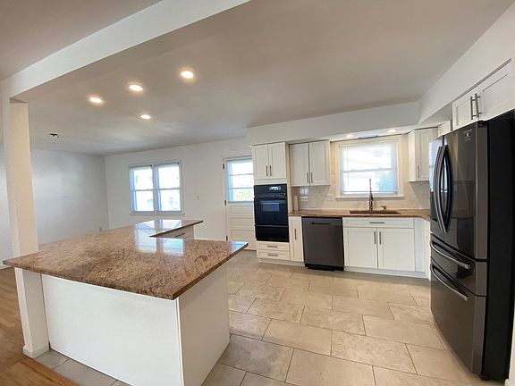 Renovated kitchen with marble counter tops