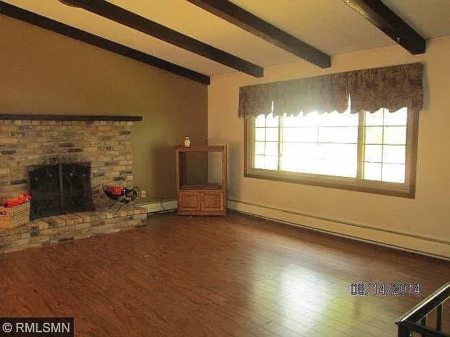 Living Room with vaulted beamed ceiling and fireplace