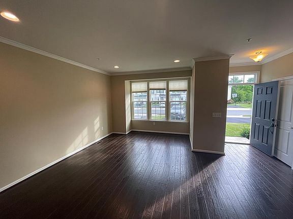 hardwood floors/ large bright living room with big windows