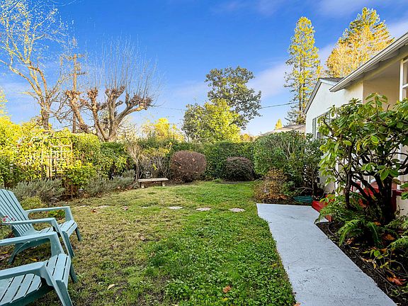 Front yard with sidewalk leading from driveway.