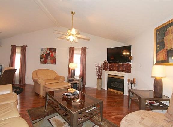 Beautiful Wood Laminate Flooring, Ceiling Fan and Cozy Fire make for enjoying time with family and friends.