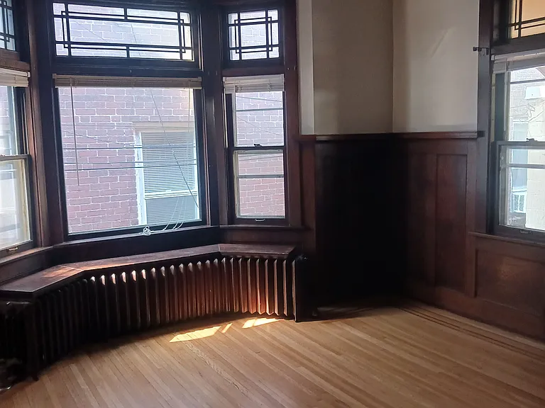 Large living area with natural 1900's woodwork and lots of light