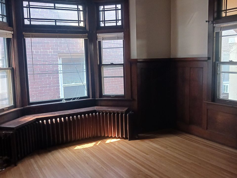 Large living area with natural 1900's woodwork and lots of light