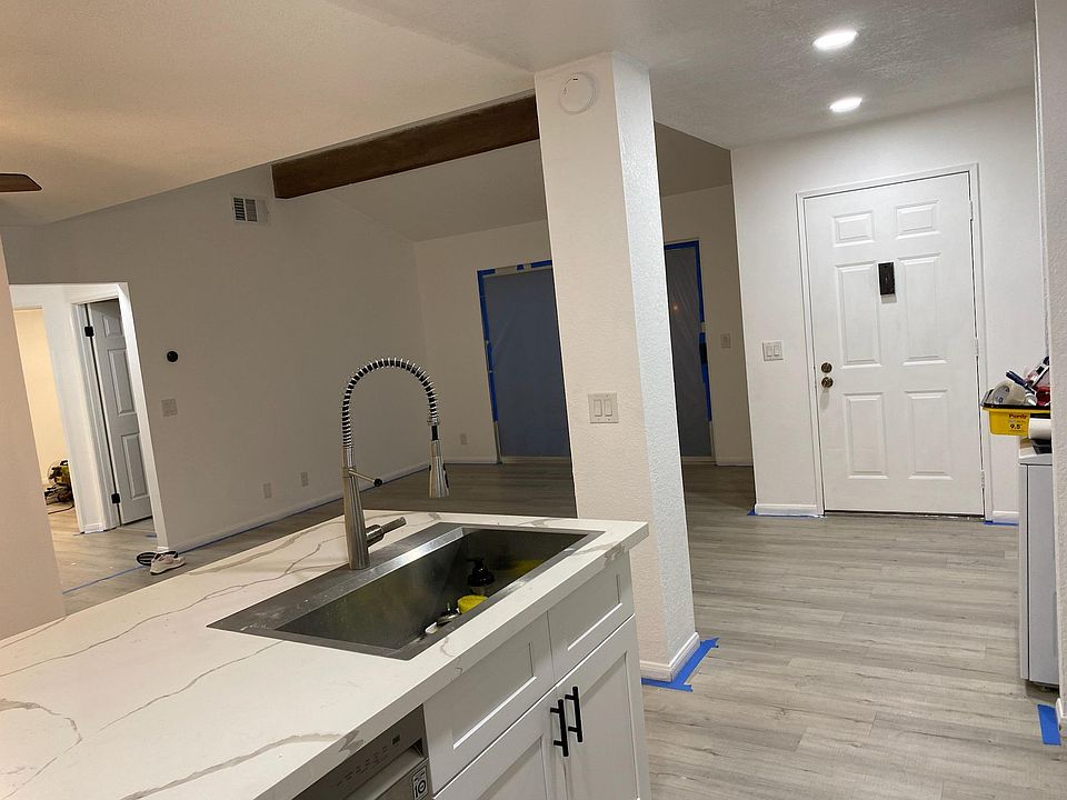Kitchen with view of living room and front door