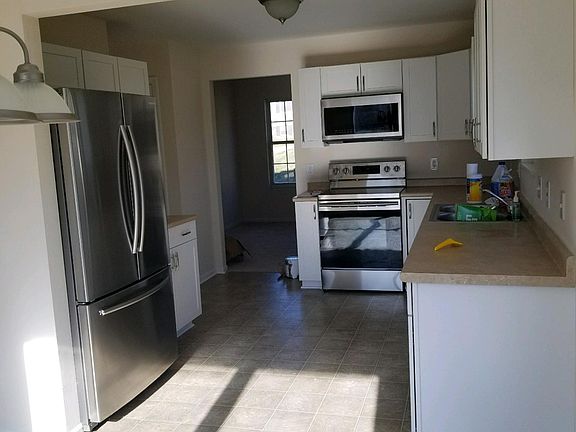 New cabinets appliances, countertops,floor,sink and disposal